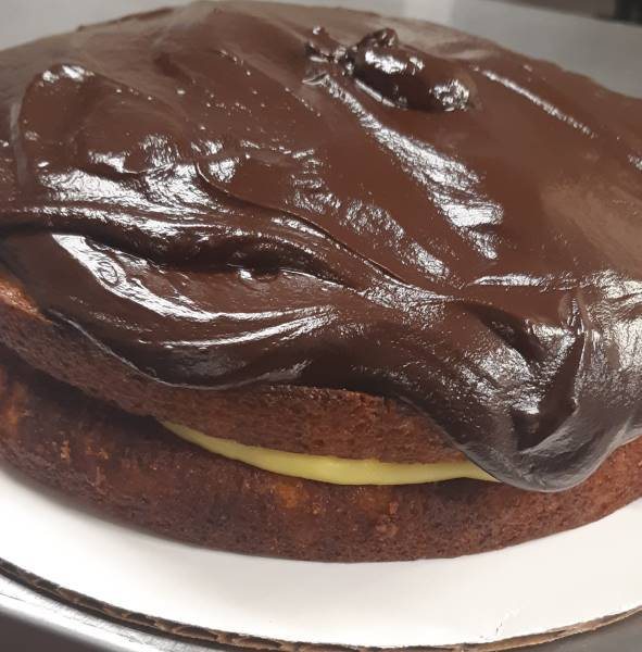 Boston Cream Pie<br>Is it a pie or is it a cake? Well whatever you want to call this delicious cake/pie. Two layers of vanilla cake with vanilla custard filling topped with a chocolate ganache.<br>Prices start at $30 and up